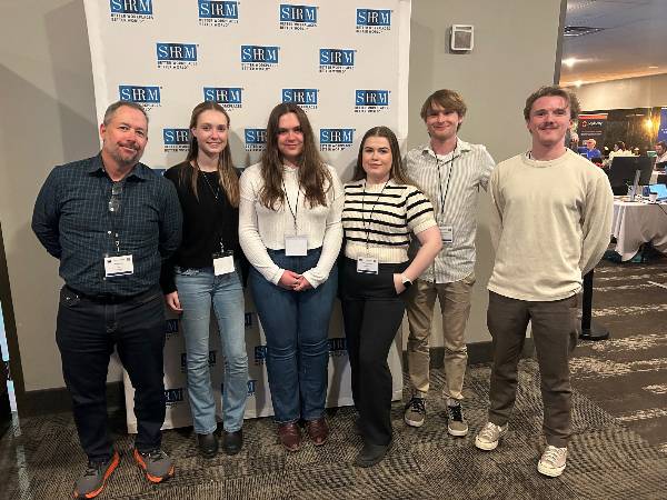 Management Club members at a conference