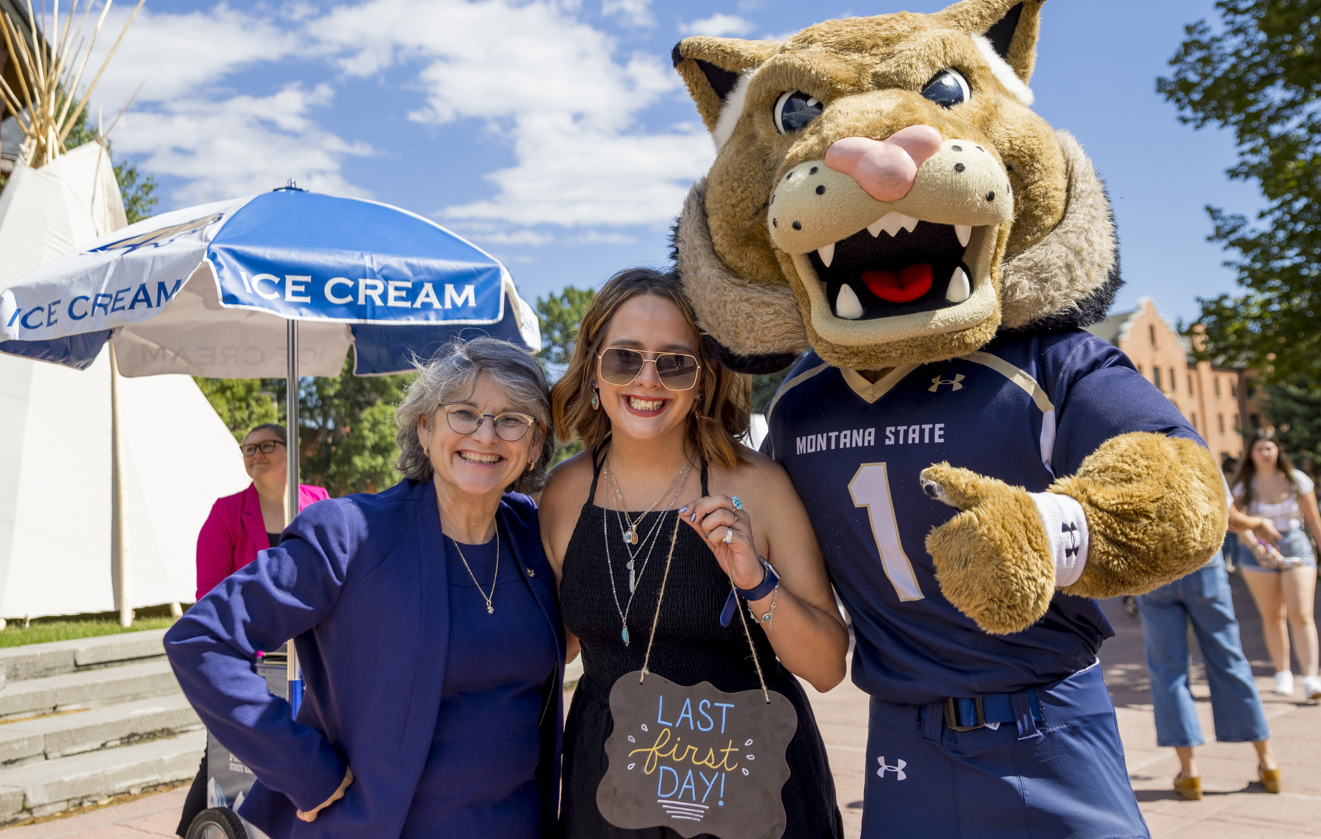 Waded Cruzado standing with Champ and a student