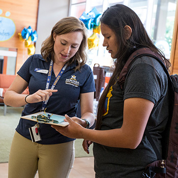 Housing staff helping student.