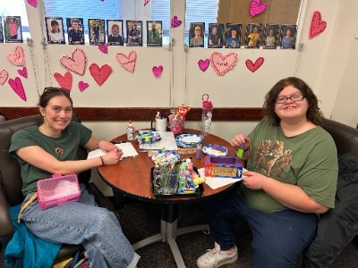 lily and anna with hearts on the wall