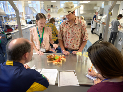 4-H members showing off their dish in 4-H Congress' "stir up" competition
