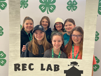 4-H members holding a sign that says "Rec Lab"