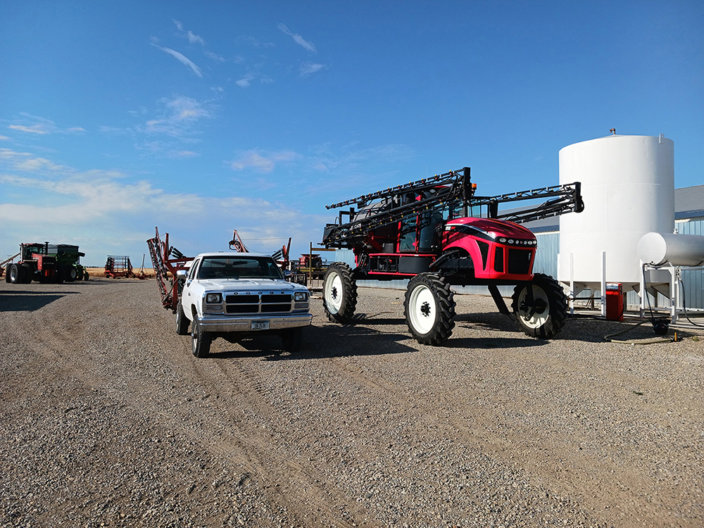 Sprayers in the farm equipment yard, both old and new