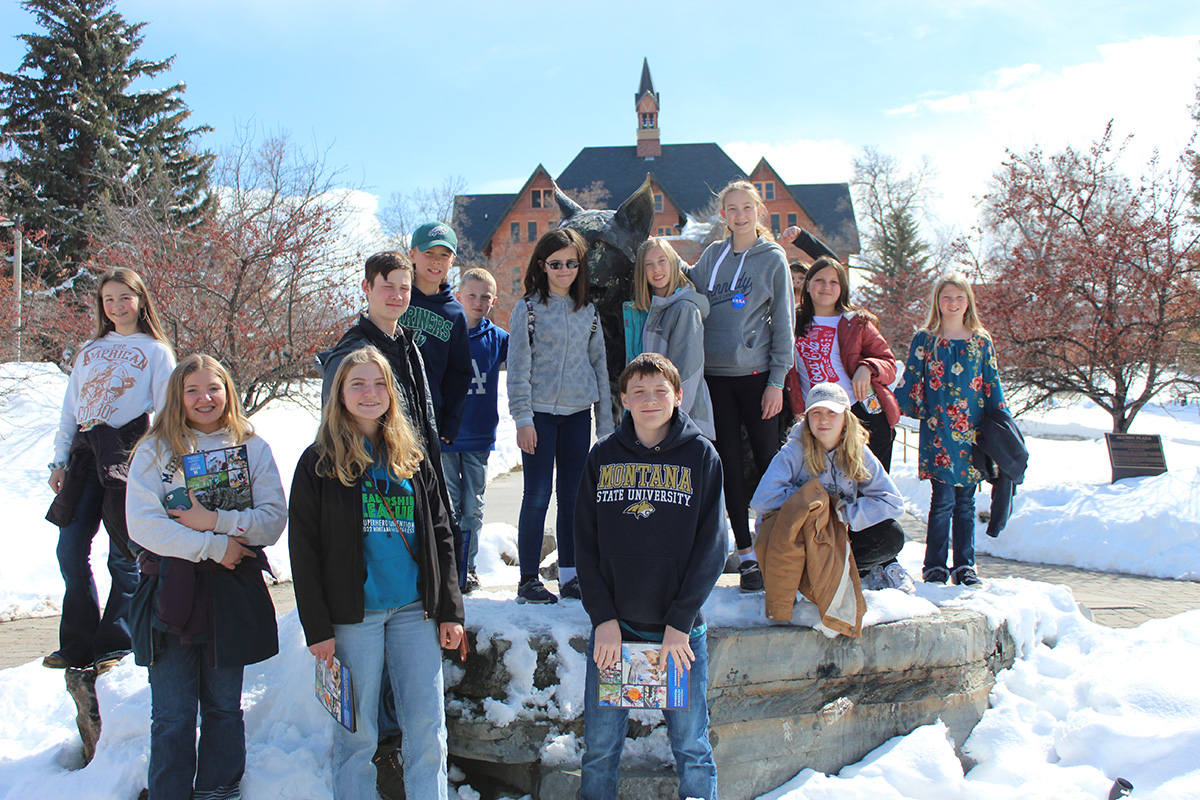 Youth members gather around Spirit during Bozeman campus tour