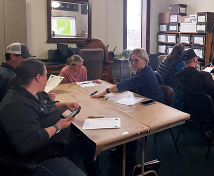 2023 Level-1 Master Gardener class participants work in the dirt in a vegetable production planting exercise