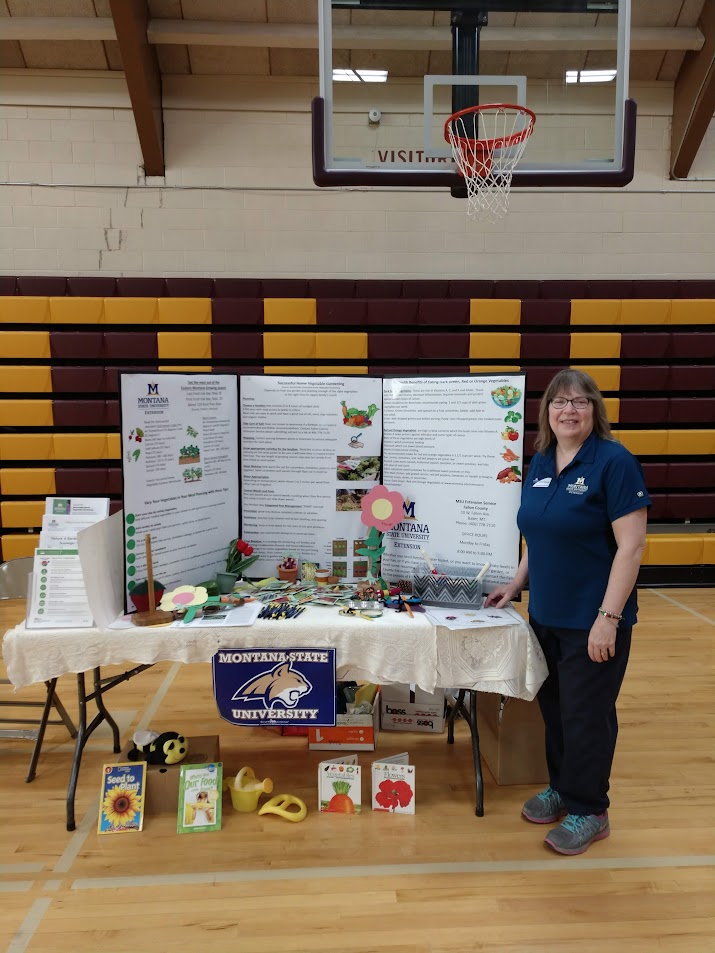 Lady standing by gardening booth 