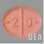 A lab image of an orange-ish red-ish pill