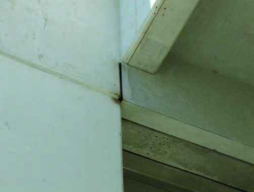 An outdoor wall seam that displays a blackish smudge.