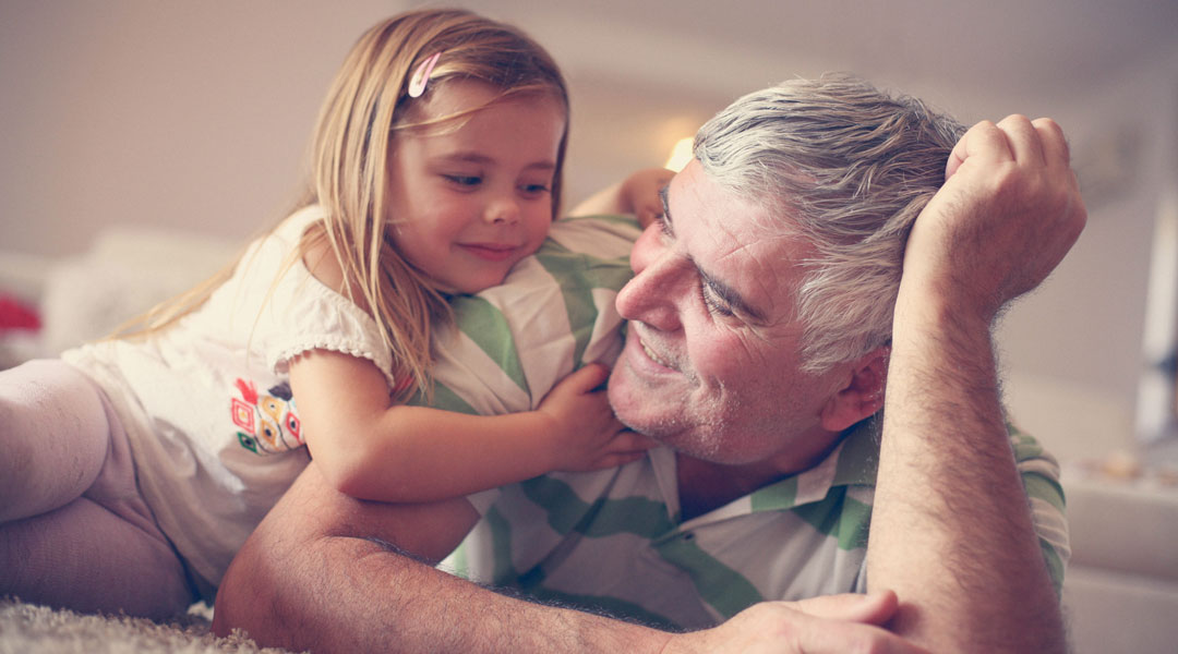 grandpa and granddaughter playing on the floor