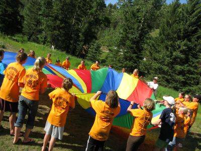 4-H members using a parachute at camp