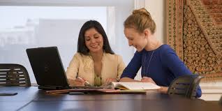 two women looking at a screen