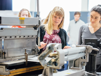 photo of two women showing device at engineering design fair