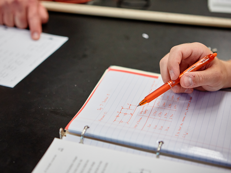 photo of a student taking notes