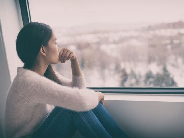 woman looking out window