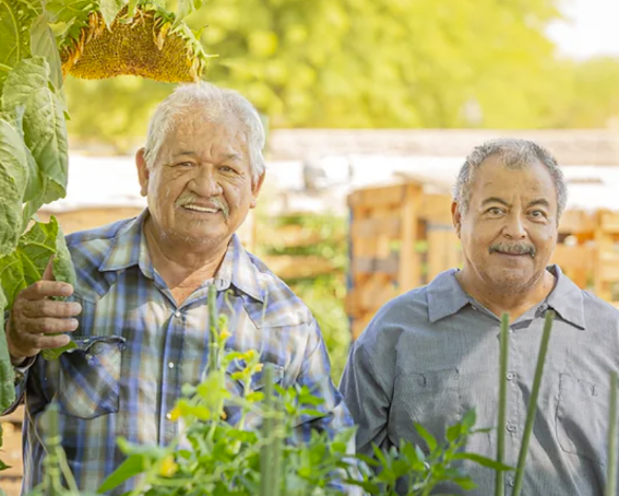 Men smile at camera.