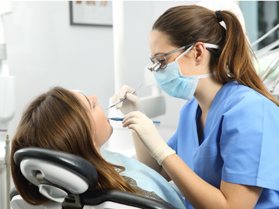 A dental hygenitist give a patient and cleaning.