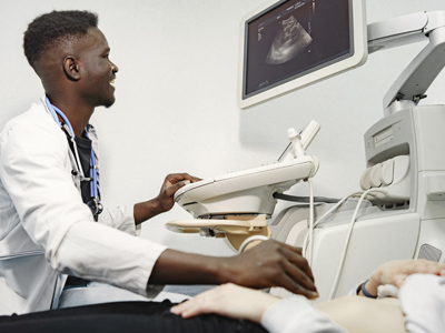 n ultrasound technician gives a pregnant woman an ultrasound examination.