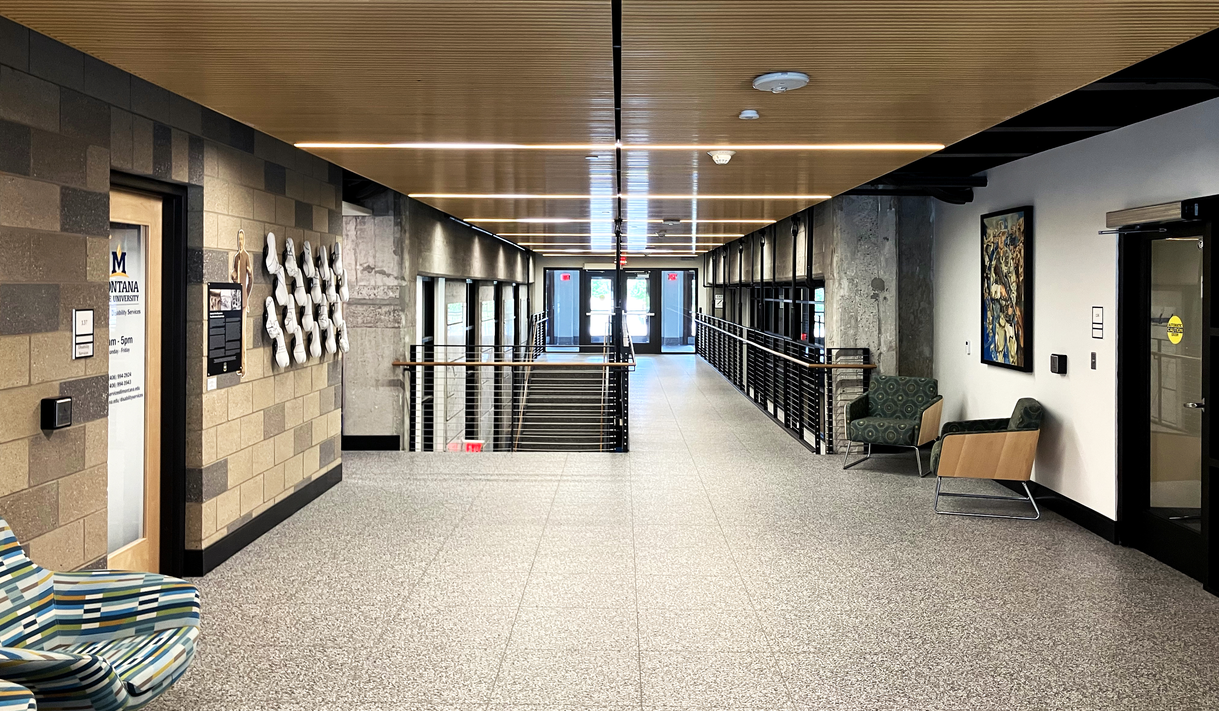 A hallway with rooms on either side
