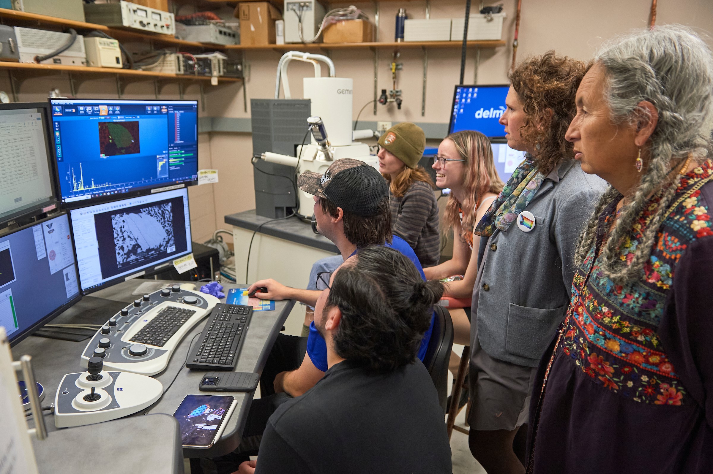 six people looking at computer screens