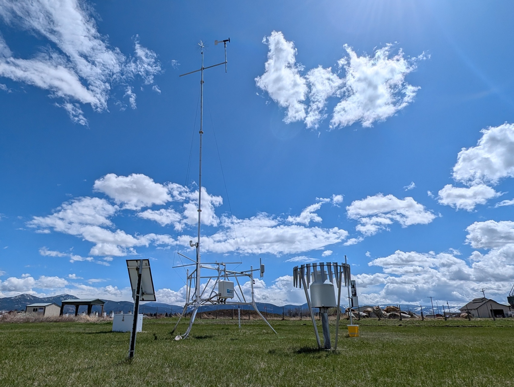 Horticulture Farm Weather Station A tower with mutliple weather sensors stands against a blue sky