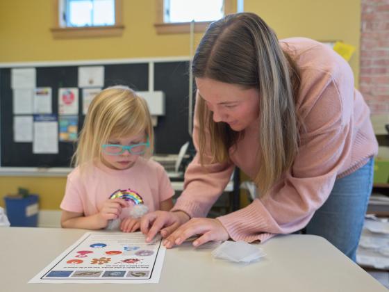 A student teacher works with an elementary student