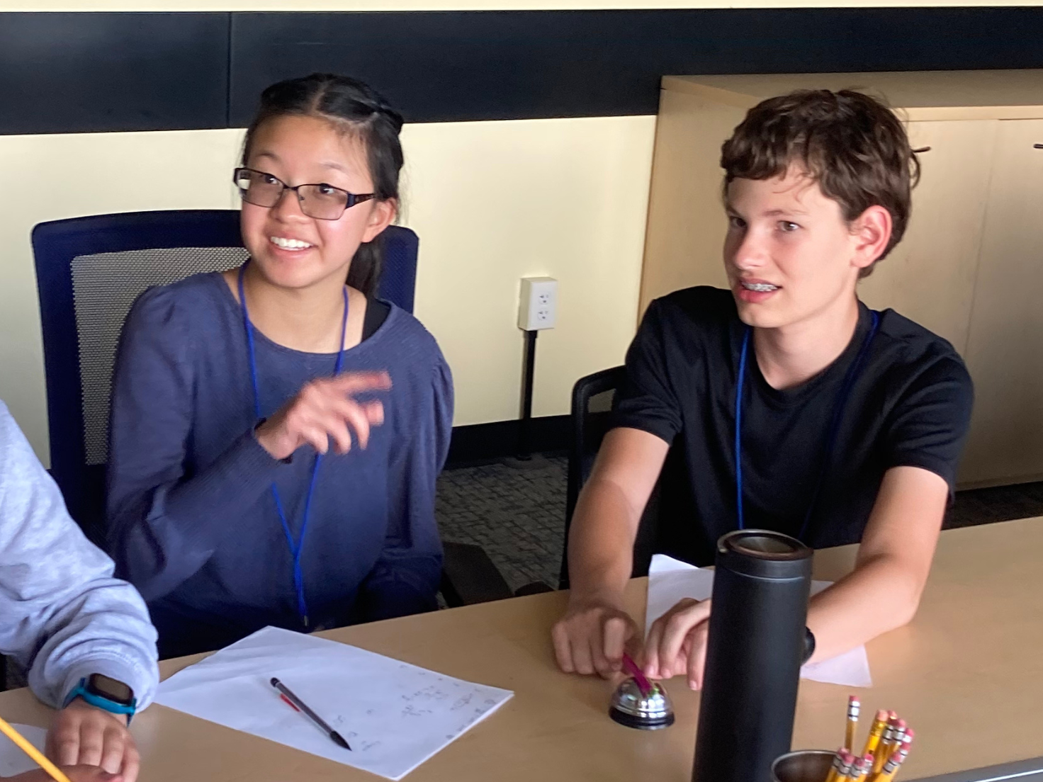 Two Math Circle students working on a problem at a table