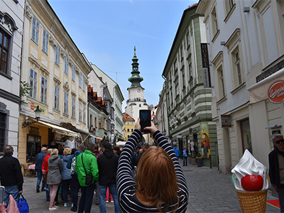 Student taking a photo of a busy European street